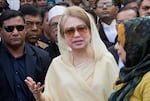 FILE- In this Dec. 28, 2017, file photo, Bangladesh's former prime minister and opposition leader Khaleda Zia, center, leaves after a court appearance in Dhaka, Bangladesh.
