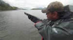 Russell Jackson with the Columbia River Intertribal Fish Commission shoots firecrackers to deter sea lions from eating salmon below Bonneville Dam.