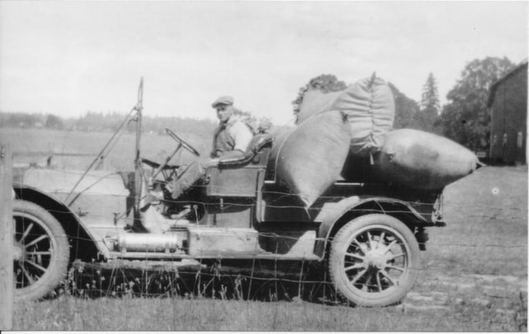 Leland Arthur Flint in old truck at Mid Valley Farm in the 1930s.
