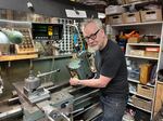 Adam Savage, host of Tested, and right to repair advocate, shows off the lathe he's fixing at his San Francisco workshop.