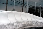 New cars are shown buried under snow after an intense lake-effect snowstorm impacted the area on Saturday in Hamburg, New York.