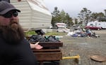 Homeless advocate Seamus McVey helped people move off the city lot at 10th Avenue and Necanicum Drive in Seaside as it was swept by police and the city.