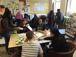 PSU admissions counselor Marshawna Williams (center, with glasses) reviews applications from Cleveland High School seniors on an "Instant Viking" event in the school's counseling center.