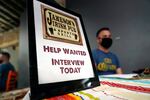 A sign on a table reads "Jameson's Irish Pub, Help wanted, interview today"