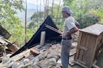 A man examines the damage to a building following an earthquake in East Manggarai, East Nusa Tenggara province, Indonesia, Saturday, Aug. 15, 2026.
