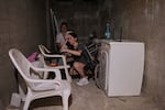 Israelis stay in a shelter of a residential area that was hit by a missile fired from Iran, in the central Israeli city of Bat Yam, early Sunday, June 15, 2025. (AP Photo/Ohad Zwigenberg)