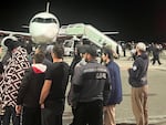 A crowd swarms the airfield of an airport in Makhachkala, in the Dagestan region of Russia, on Sunday night.