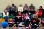 Florida School for the Deaf and Blind Cobras player Lily James dives to save the ball from the goal against the Utah Foundation for the Blind and Visually Impaired Rage during the Junior Cascade Classic goalball tournament at the Washington State School for the Blind in Vancouver, Wash., on Nov. 1, 2025.