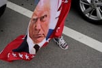 A flag featuring Donald Trump waves amid a group of supporters near Mar-a-Lago, Fla., in 2024.