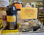 Ken Yu serves complimentary cups of "healthy lung tea" at his shop, Wing Ming Herbs, in Southeast Portland, Ore., Tuesday, Feb. 18, 2020.