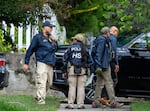 Homeland Security officers leave the Washington residence of Rep. Ilhan Omar, D-Minn., after a search, Monday, Oct. 12, 2026.