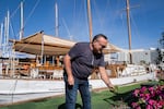 Shmulik Zino on his 30-foot wood-trimmed tour boat. Normally Zino would be taking tourists for boat cruises on the Gulf of Aqaba. These days he tends to his herb and flower garden.