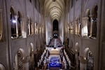 The choir, clergy and guests stand as they sing during a ceremony to mark the reopening of the landmark Notre Dame Cathedral, in central Paris, on Saturday.