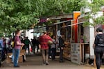 Customers line up in front of food carts on Southwest Alder Street in downtown Portland. The pods must vacate the space by June 30, 2019.