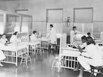 Nurses attend to patients in this historical photo of the children's ward inside Wheatley-Provident Hospital, a Black hospital in Kansas City, Missouri. It opened in 1918, but, like most Black hospitals, it closed following the federal campaign to desegregate hospitals in the 1960s. 