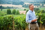 Undated photo of Bill Stoller holding a glass of wine at Stoller Family Estate in Dayton, Ore. Stoller dies at 74 on April 23, 2025.