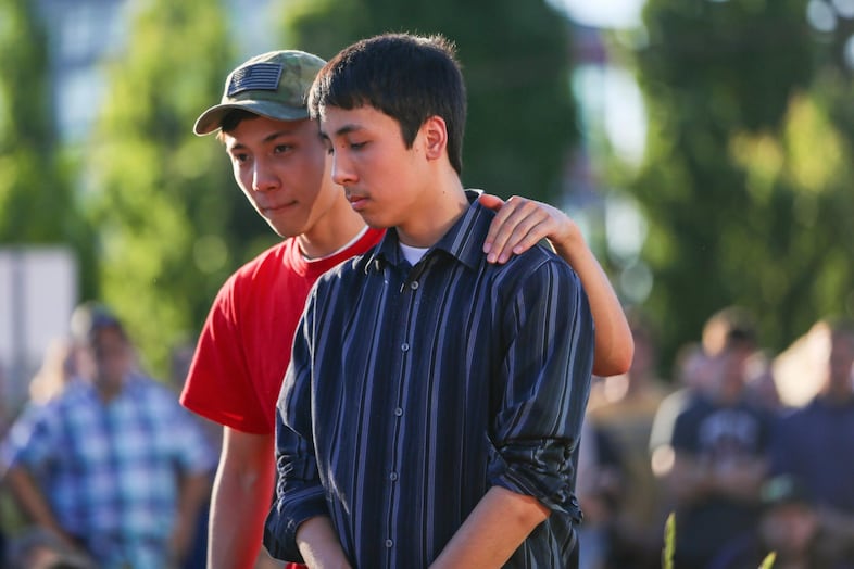 Friends of the victims embrace.