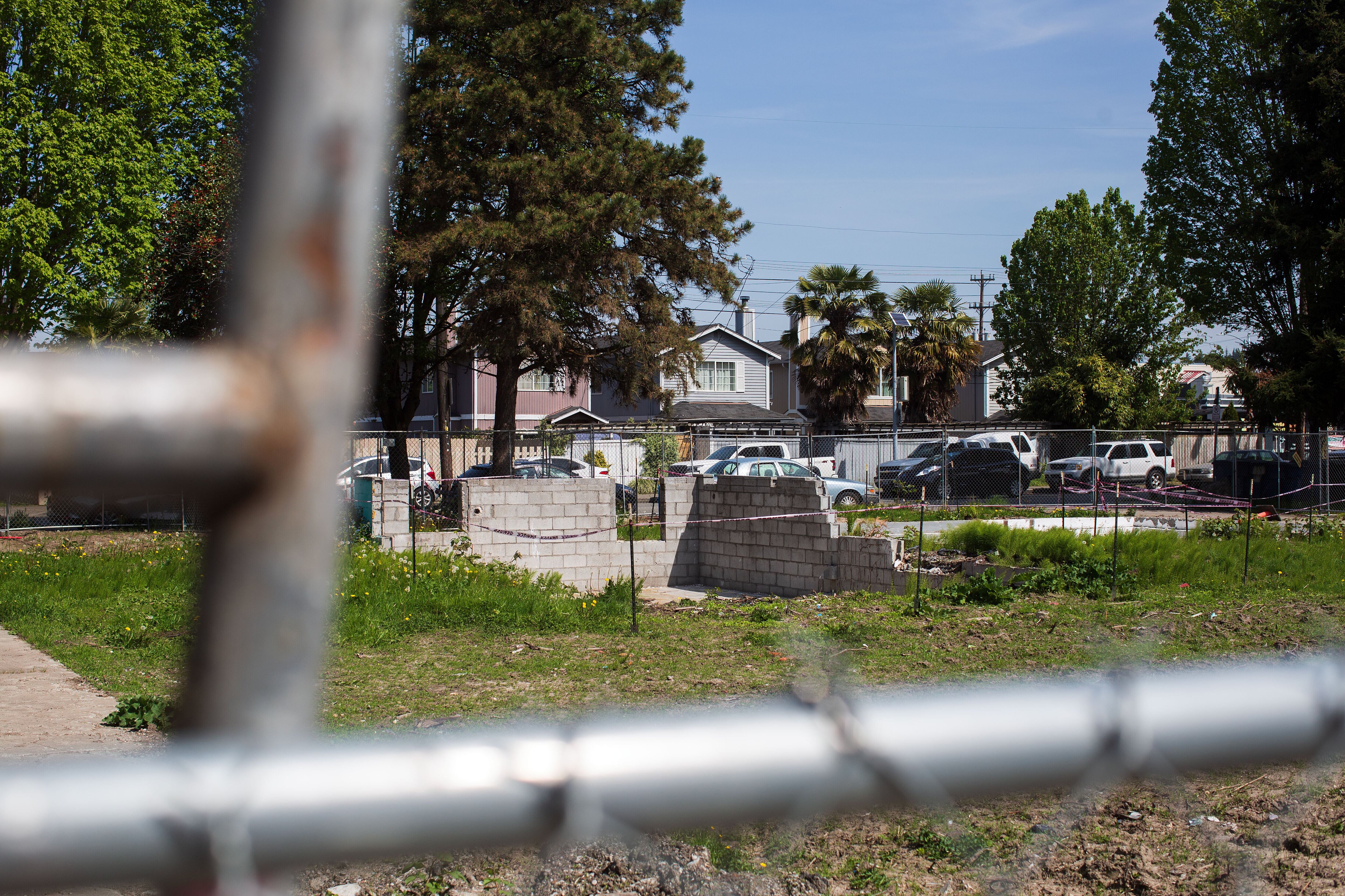 In Seattle's South Park neighborhood, residents have about half as much tree canopy as the citywide average. Four single-family homes once stood on this lot, where 22 new units will soon be built. Plans filed with the city show three large evergreens and several smaller trees that are still standing on the lot are slated for removal.