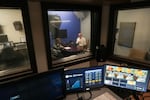 Sarah Downs (left), director of production and video programming at WNIN, talks with Zac Heronemus, CEO of Tri State Food Bank, about an upcoming appearance on the station's Newsmakers series.