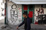 A man walks near a mural of Handala in the village of al-Fara, in the occupied West Bank, following an Israeli raid on Dec. 8.