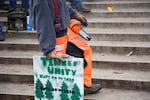A man holds a Timber Unity sign at a rally at the state Capitol in Salem in June.