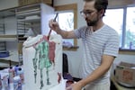 Artist and veteran Daniel Donovan painting one of his clay replicas of the millitary's standard-issue, five-gallon water can. This one has a painting of a boy scout holding a wooden gun. "A lot of my thesis work in graduate school now is dealing with constructs in society that help define aspects of masculinity," says Donovan.