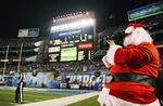 A television camera operator is dressed as Santa Claus during the Baltimore Ravens and San Diego Chargers game on Dec. 18, 2011, at Qualcomm Stadium in San Diego.