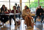 Lyta Noijaroen, 4, covers her ears sitting on her mom Phantipha’s lap. Noijaroen is slated to be a Winterhaven Elementary School student in 2027, the year by which changes in the district will happen.