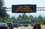 A file photo of a sign on U.S. Highway 26 outside of Portland encouraging people to get their COVID-19 vaccination, taken June 28, 2021.