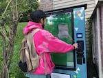 Brian taps in the code to dispense fentanyl test strips from the new harm reduction vending machine in North Adams, MA. Anyone can get the test strips for free. But to receive drug-use supplies like needles and pipes, clients of the nearby clinic must register for an access code. The machine is cooled and heated to preserve medications like Narcan.