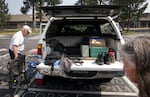 Tim Draxler, left, and his wife Barbara organize their belongings after a night at a Red Cross shelter in Sisters, Ore., July 23, 2026. The couple was evacuated from their home outside of Sisters under Level 3 “Go Now” orders on Wednesday evening as the Akawa Butte Fire burns through the area.