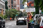 FILE - Protester Daryn Herzberg stands in front of the federal courthouse in Portland, Ore. on Friday, Oct. 2.
