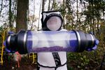 Sven Spichiger, Washington State Department of Agriculture managing entomologist, displays a canister of Asian giant hornets vacuumed from a nest in a tree behind him Saturday, Oct. 24, 2020, in Blaine, Wash. 