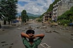 A boy looks at the devastation caused by flash flooding along the Trishuli River in Nepal's Nuwakot district, Wednesday, Aug. 26, 2026.