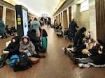 People sit in the Kyiv subway, using it as a bomb shelter in Kyiv, Ukraine, Thursday, Feb. 24, 2022. Russia has launched a full-scale invasion of Ukraine, unleashing airstrikes on cities and military bases and sending troops and tanks from multiple directions in a move that could rewrite the world's geopolitical landscape.