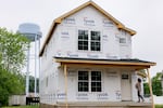 Becca Morris stands on the front porch of her future home, in Harrington, Delaware, on Wednesday, May 14, 2025. (Wesley Lapointe/ for NPR)