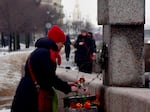 A woman lays flowers at the Memorial to Victims of Political Repression to pay respect to Alexei Navalny in Saint Petersburg on Saturday.
