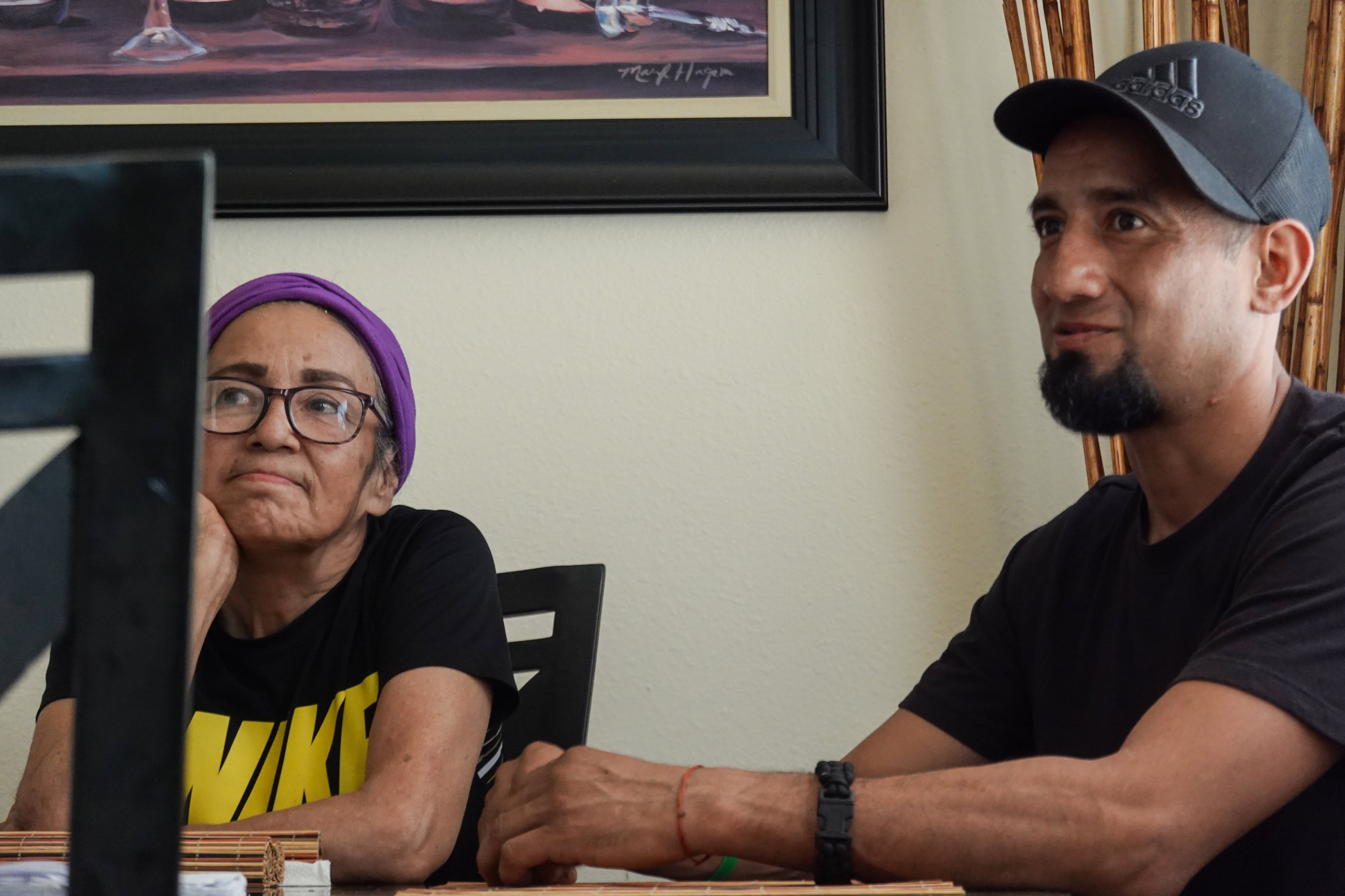 Maria de Lourdes Navarro, and her son, David Montiel sitting at the dinner room table, on Sep. 24, 2025. They say they're making less money now compared to three years ago. Oregon passed its overtime law for farmworkers in 2022.
