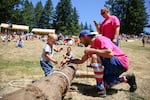 Wes Young assists his 2-year-old son, Daniel, during the children's choker setting competition.