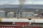 On March 10, 2023, smoke emanates from a railroad ties treatment plant in The Dalles, Ore., after a fire and explosion from the night before.