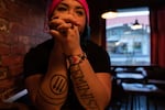 Rosie Strange sits in a restaurant after the Women’s March on Jan. 19, 2019 in The Dalles, Ore. Her left arm says "FEMINIST" and her right arm has an anti-fascist symbol on it.