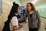 Oregon Gov. Kate Brown talks with a student at Madison High School in Portland.