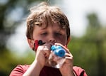 Austin blows bubbles on the playground during the last day of school at Earl Boyles Elementary for the 2014-2015 academic year.