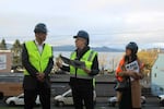 Oregon Gov. Tina Kotek, center, talks with Northwest Oregon Housing Authority executive director Hsu-Feng Andy Shaw on the site of the future Owens Adair II affordable apartments.