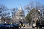 Workers install no-scale fencing around the U.S. Capitol in Washington, Thursday, Jan. 7, 2021. President-elect Joe Biden's inauguration was already going to be scaled back, but after a mob stormed the U.S. Capitol, ransacking the building and triggering chaos that stretched all the way to the Senate floor, questions began to arise about whether having a presidential ceremony on the steps of the same building could also pose serous security risk.