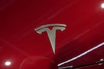 The logo of Tesla car is pictured at the Paris Auto Show, in Paris on Oct. 14, 2024.