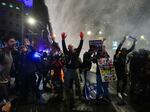 Police in Tel Aviv, Israel, use water cannons to disperse demonstrators during a protest against Israeli Prime Minister Benjamin Netanyahu's government, and calling for the release of hostages held in the Gaza Strip by Hamas, on Saturday.