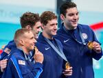 The United States men's 4x100-meter freestyle relay team celebrate after winning the gold medal at the 2024 Summer Olympics on Saturday in Nanterre, France.