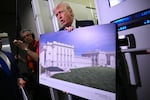 President Trump holds a rendering of the East Wing modernization while speaking to reporters aboard Air Force One on Sunday.