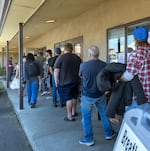People line up outside the Salvation Army building in Pendleton, Ore., on May 3, 2026, for Sunday lunch provided by Altrusa of Pendleton, a local community organization.